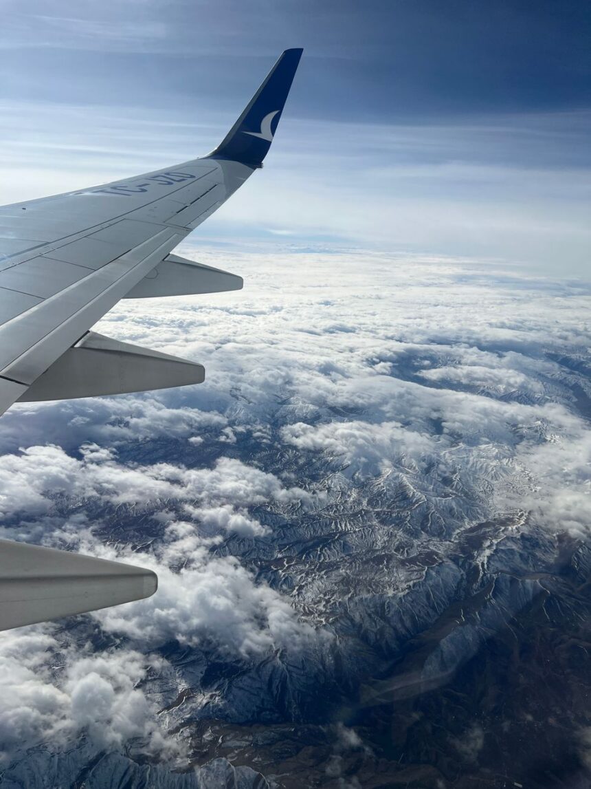view of clouds and mountains from an airplane